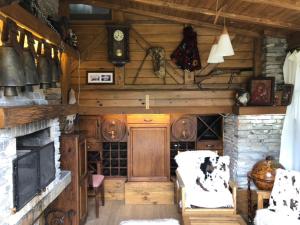 a living room with a clock on the wall at Katarino Villa Nature Escape in Razlog