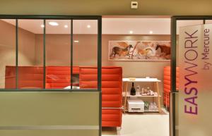 a store with red furniture in a room at Mercure Périgueux Centre Historique in Périgueux