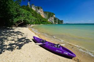 a purple kayak sitting on a beach next to the water at Railay Great View Resort in Railay Beach