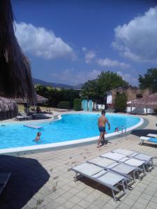 a man walking by a swimming pool at Appartamento Santacroce in Pratola Peligna