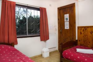 Postel nebo postele na pokoji v ubytování Hostel Inn Bariloche