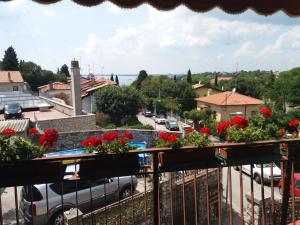 a balcony with flowers and a view of a street at Affittacamere Il Veliero in Duino