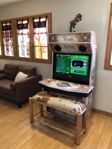 a living room with a television in a box at Montana Chalet Hôtel & Spa in Le Sauze
