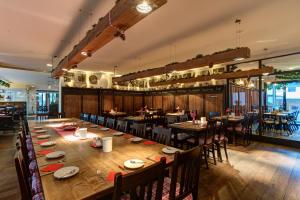 a large dining room with a long table and chairs at Hotel Stern by EMPA in Ulm