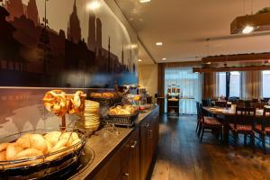 a kitchen with a counter with baskets of bread at Hotel Stern by EMPA in Ulm +22 photos