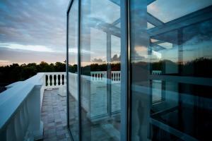 a view from the balcony of a house with glass walls at Vila Komoda in Palanga