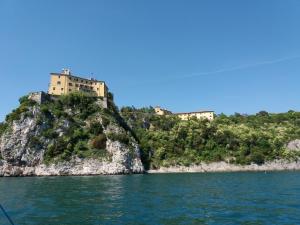 a castle on top of a hill in the water at Affittacamere Il Veliero in Duino