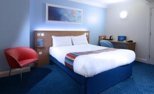 
a hotel room with a bed and a desk at Travelodge Waterford in Waterford
