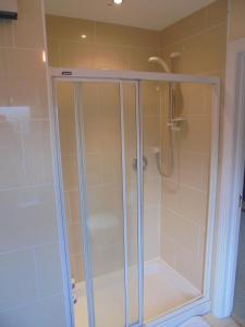 a shower with a glass enclosure in a bathroom at Applewood Heights in Glenariff