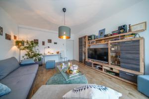 a living room with a couch and a tv at Apartment Happy Day in Varaždin