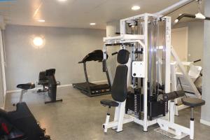 a gym with several exercise equipment in a room at City Lodge Appart Hôtel Niort in Niort