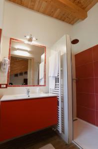 a bathroom with a sink and a mirror at Albergo Sporting in Peio Fonti