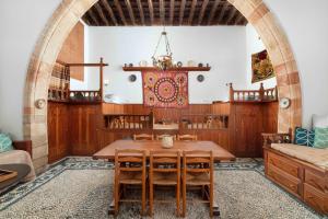 a dining room with a wooden table and chairs at Captains House in Lindos