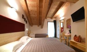 A bed or beds in a room at Albergo Sporting