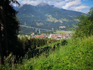 a view of a town with a bridge in the mountains at Römerstraße 10 KG, Appartement Inntal in Innsbruck