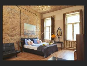a bedroom with a bed and a brick wall at Budapest Loft Central Design Home in Budapest