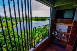 a view out of a window of the water at Na Siri Lake View in Samut Prakan