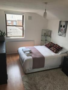 a bedroom with a large bed and a window at Amazing Room in London