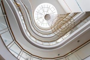 a spiral staircase in a building with windows at Alfagar Alto da Colina in Albufeira