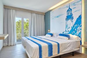 
a bedroom with a bed and a painting on the wall at Sol Bahía Ibiza Suites in San Antonio
