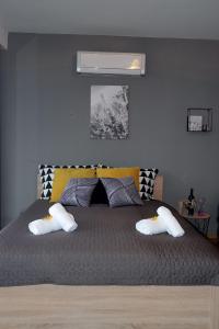 a bedroom with a large bed with two pillows at Studio apartman Kristina i Anamaria in Zagreb