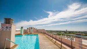 a balcony with a swimming pool on top of a building at Apartaments Cambrils Suite Costa Daurada in Cambrils