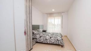 a bedroom with a bed and a large mirror at Apartaments Cambrils Suite Costa Daurada in Cambrils +30 photos