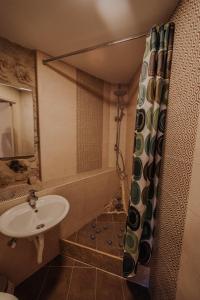 a bathroom with a sink and a shower at Eleutheria in Kalamata