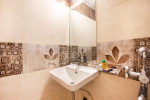 a bathroom with a sink and a mirror at Hygienic Hotel Liberty Plaza in Mumbai