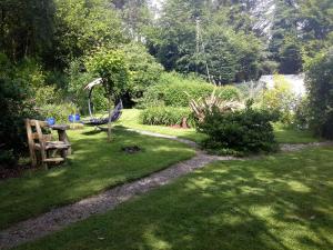 a garden with a table and a bench in the grass at Grove lodge in Aglish
