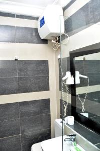 a bathroom with a sink and a mirror at Primal Hotel in Ikeja
