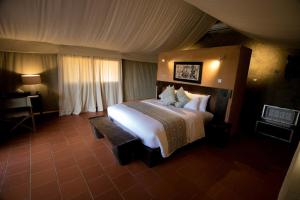 a bedroom with a large bed in a room at Zaina Lodge in Mole