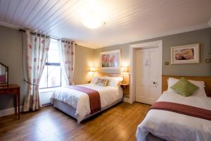 Ένα ή περισσότερα κρεβάτια σε δωμάτιο στο Brennan's Accommodation Glenties