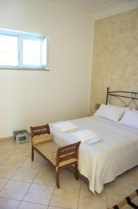 a bedroom with a large bed and a bench at La Terrazza sul Mare in Capri