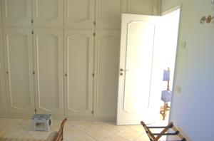 a room with white cabinets and a window at La Terrazza sul Mare in Capri