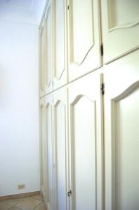 a white closet with white cabinets in a room at La Terrazza sul Mare in Capri