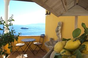a balcony with a view of the ocean and a boat at La Terrazza sul Mare in Capri