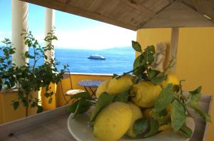 a plate of pears on a table with a view of the ocean at La Terrazza sul Mare in Capri