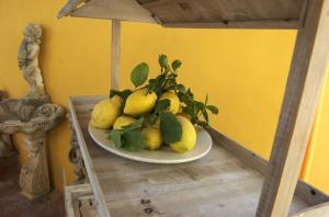 a plate of lemons sitting on a table at La Terrazza sul Mare in Capri