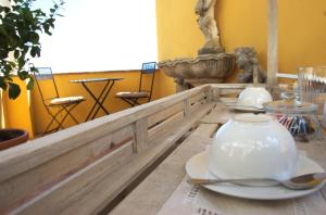 a table with a tea pot and plates on it at La Terrazza sul Mare in Capri