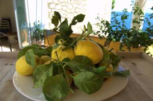 a plate of lemons sitting on a table at La Terrazza sul Mare in Capri