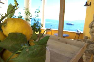 a bunch of lemons sitting on a table with a window at La Terrazza sul Mare in Capri