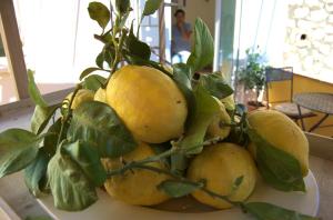 a pile of lemons sitting on top of a table at La Terrazza sul Mare in Capri