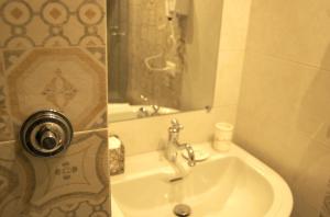 a bathroom with a sink and a mirror at La Terrazza sul Mare in Capri