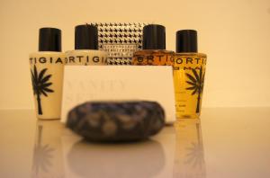 a group of three bottles of oil and a rock at La Terrazza sul Mare in Capri