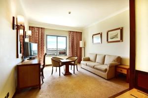 a living room with a couch and a table at Hotel Real Oeiras in Oeiras