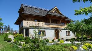a house with solar panels on the roof at Chata Istebna in Istebna