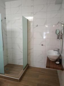 a bathroom with a sink and a shower at City Center Studios in Kavála