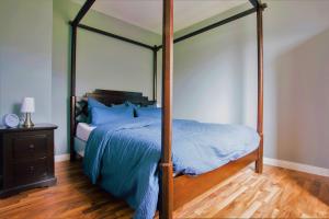 a bedroom with a canopy bed and a wooden floor at Haus Moselwiese in Alf