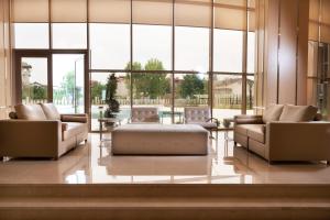 um átrio com sofás e mesas e janelas grandes em TRYP by Wyndham Izmit em Cocaeli